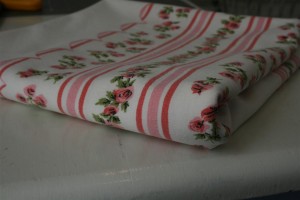 folded pink and white vintage tablecloth