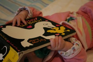 baby playing with book