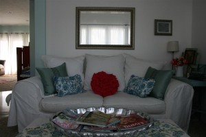 white couch with turquoise and pink pillows