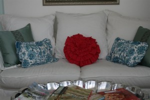 couch with pink and turquoise pillows