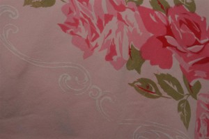 pink roses and white detail on vintage tablecloth