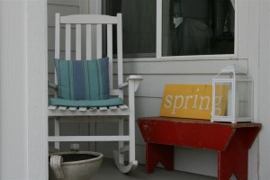 rocking chair with red bench and spring sign