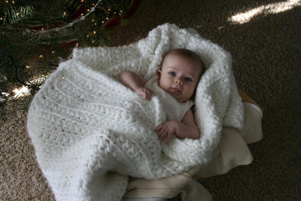 baby wrapped in white blanket