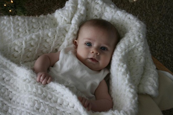 baby in white blanket