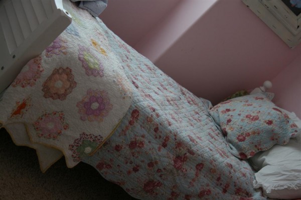 bed with vintage quilt