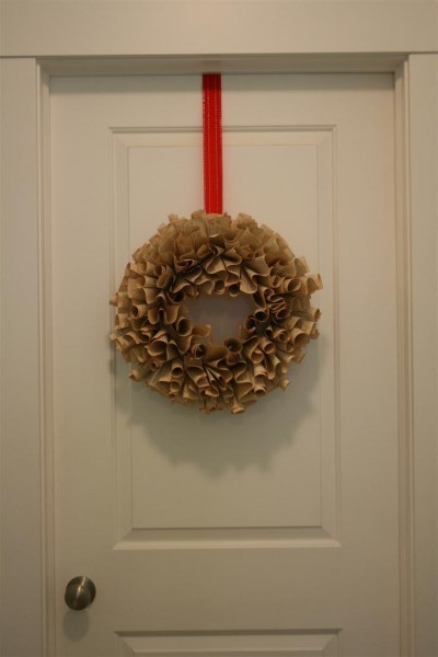 book page wreath hanging on door