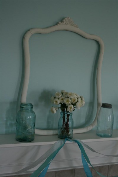 vintage jars and empty frame on mantel