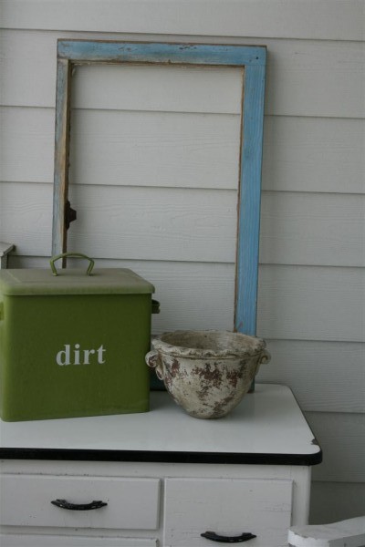 vintage cabinet with dirt bin and window frame