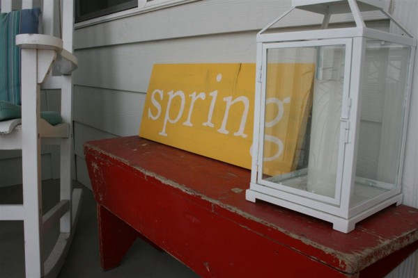 red bench with "spring" sign